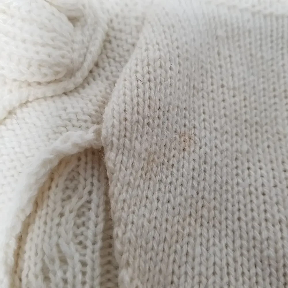 small girl doggie light sweater  one small faint stain on underside of sweater